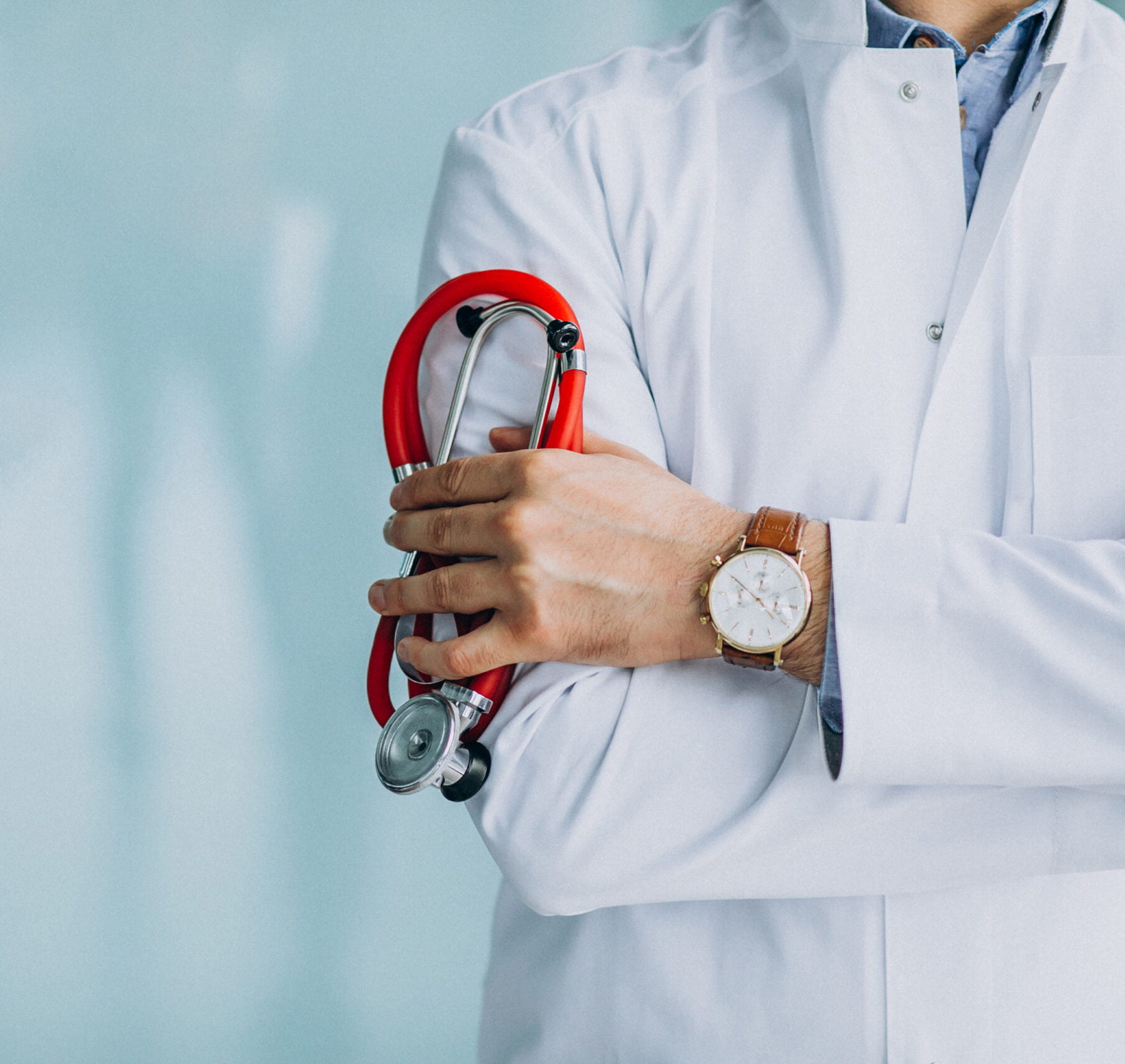 Young handsome physician in a medical robe with stethoscope
